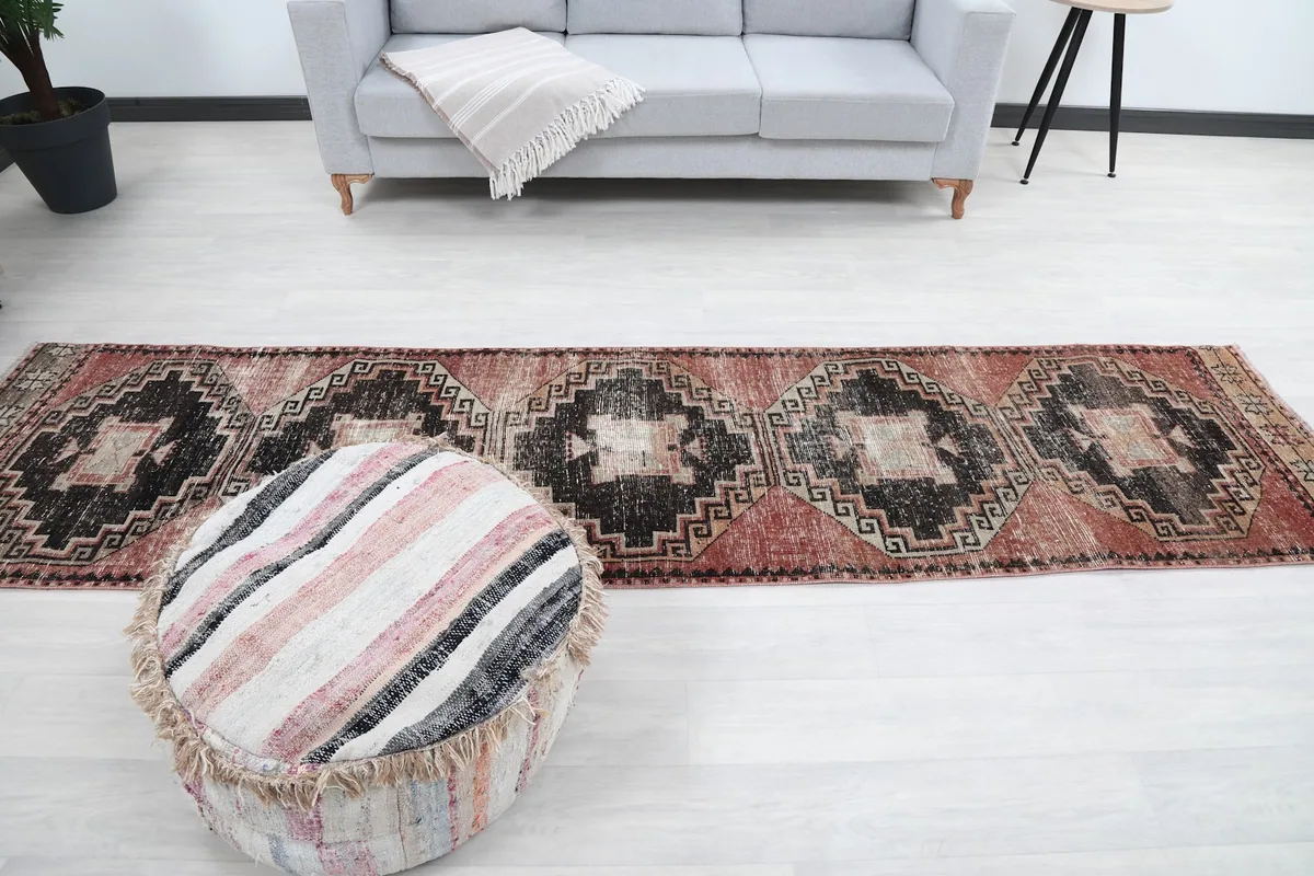 Overhead view of the runner rug in a room, positioned in front of a light gray sofa