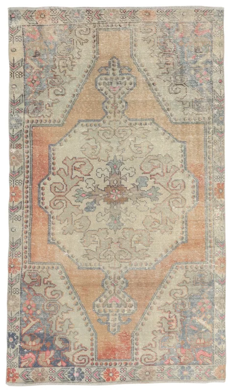 Full top view of the 4x7 vintage Anatolian rug with a rust and beige medallion design