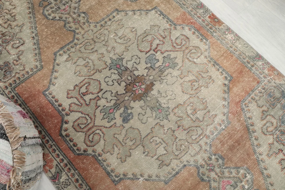 Overhead angle showing the intricate floral motifs within the central beige medallion
