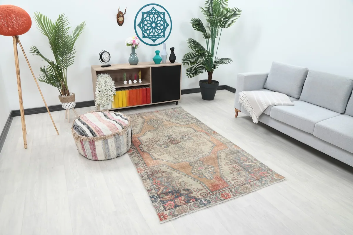 Angle view of the rug in a living room, highlighting its placement next to a sofa and ottoman
