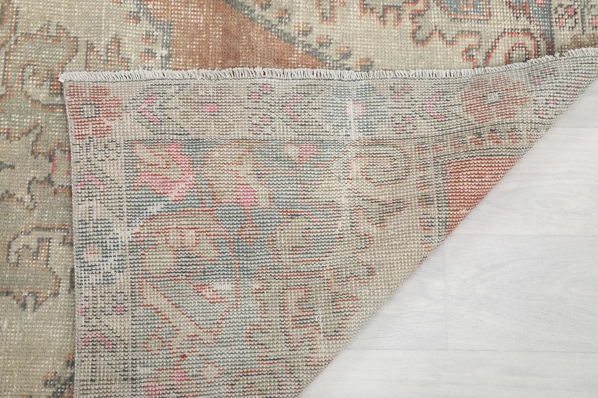 Closer view of the rug's reverse side, showing the dense knotting of the wool on cotton