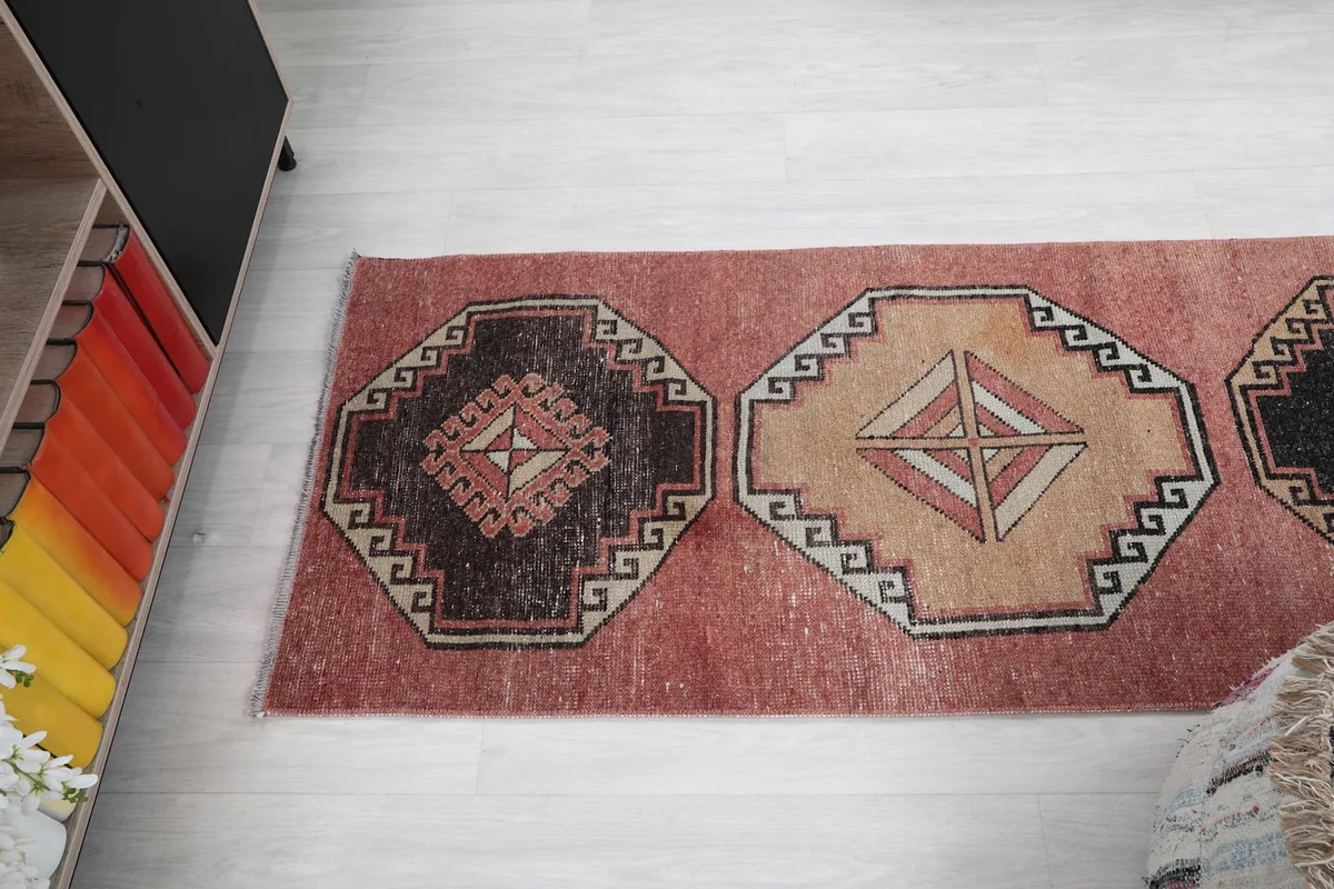 Angled top view of a section of the runner rug, focusing on two medallions.