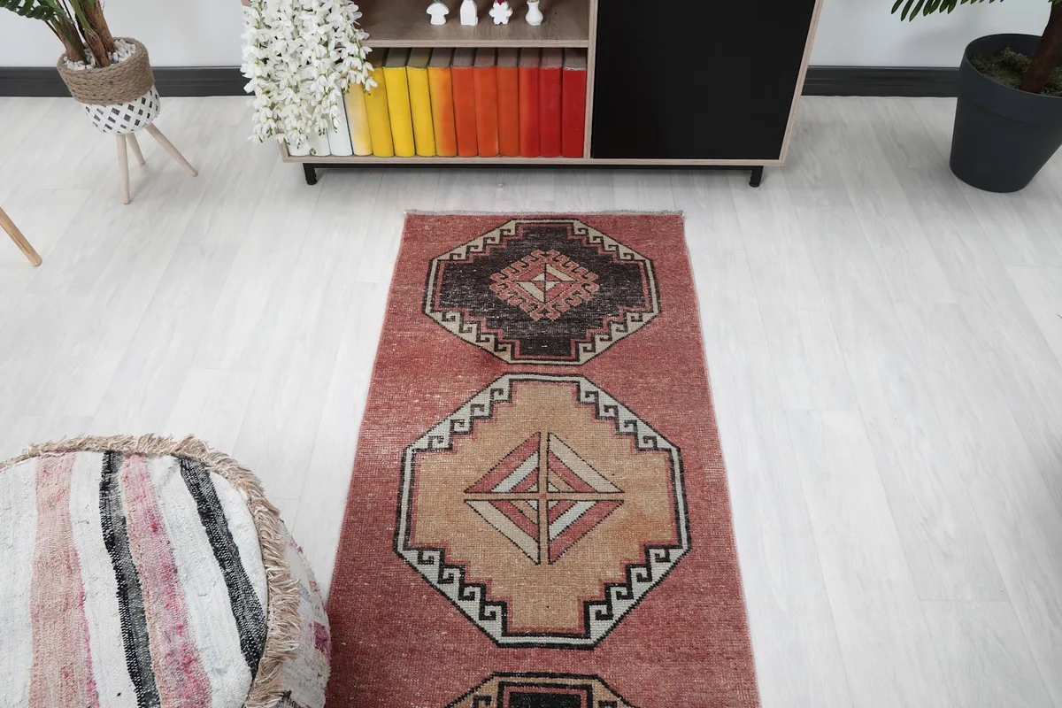 Overhead view of the rug in a room setting, showing the repeating medallion design.