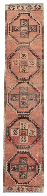 Full overhead view of the rust runner rug with geometric medallions on a white background