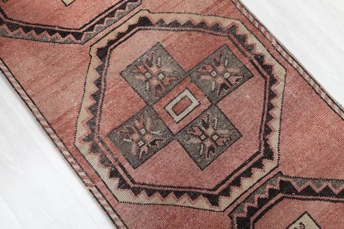 Angle shot highlighting the repeating geometric medallion pattern down the runner