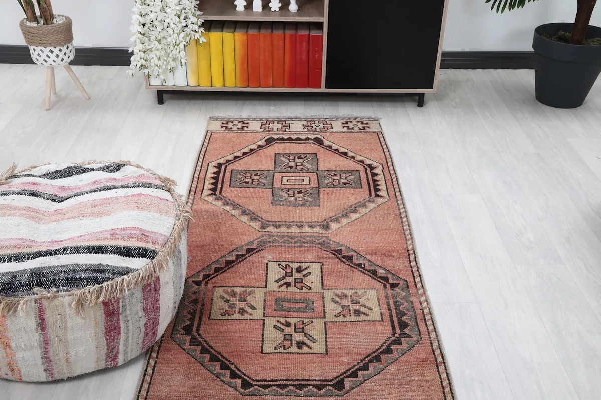 Elevated view of the runner rug in a room, showing its position relative to a cabinet and ottoman