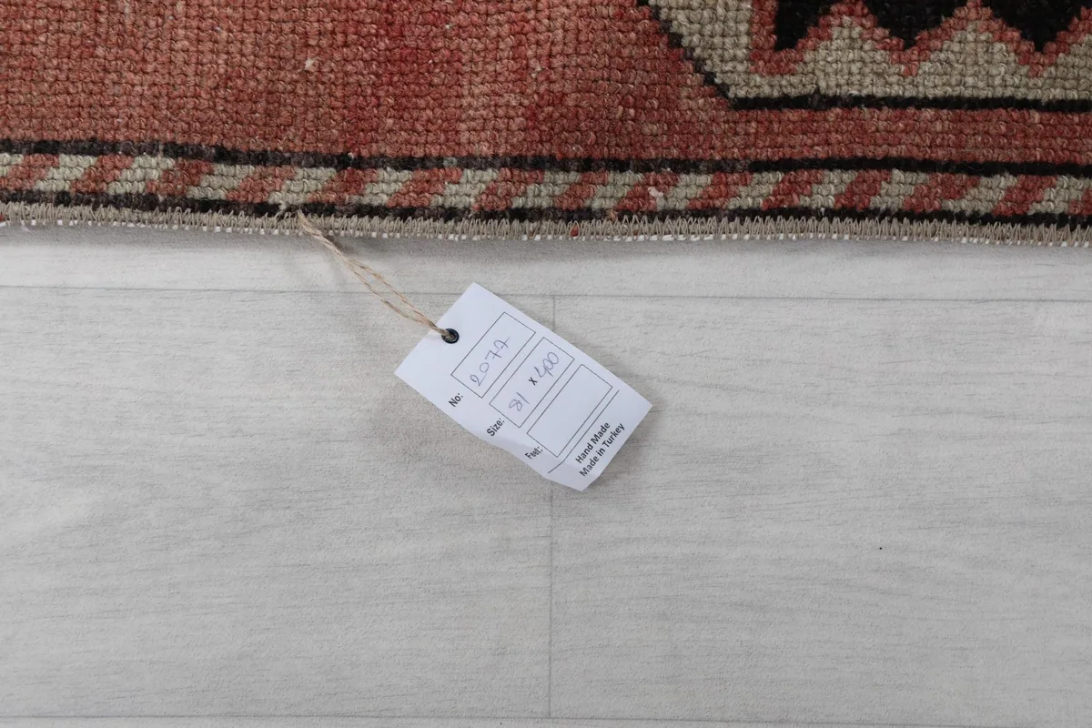 Close-up of the product tag attached to the rug, displaying size and origin information