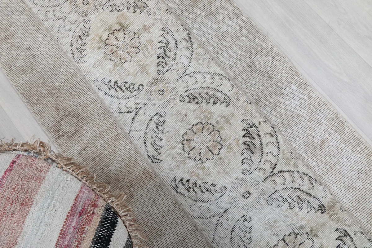 Angled shot highlighting the rug's central design and the subtle color variations in the pile.