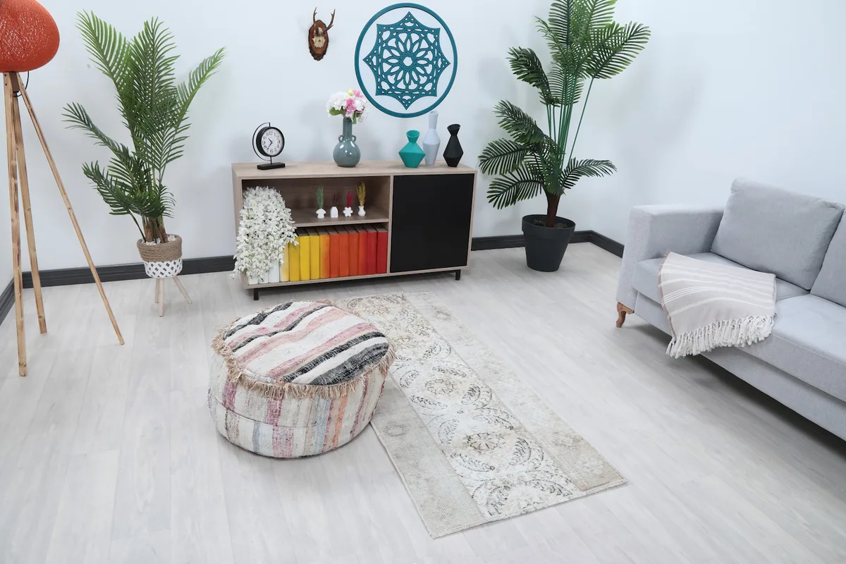 Overall view of the cream and gray runner rug in a room setting, showing its length and placement.
