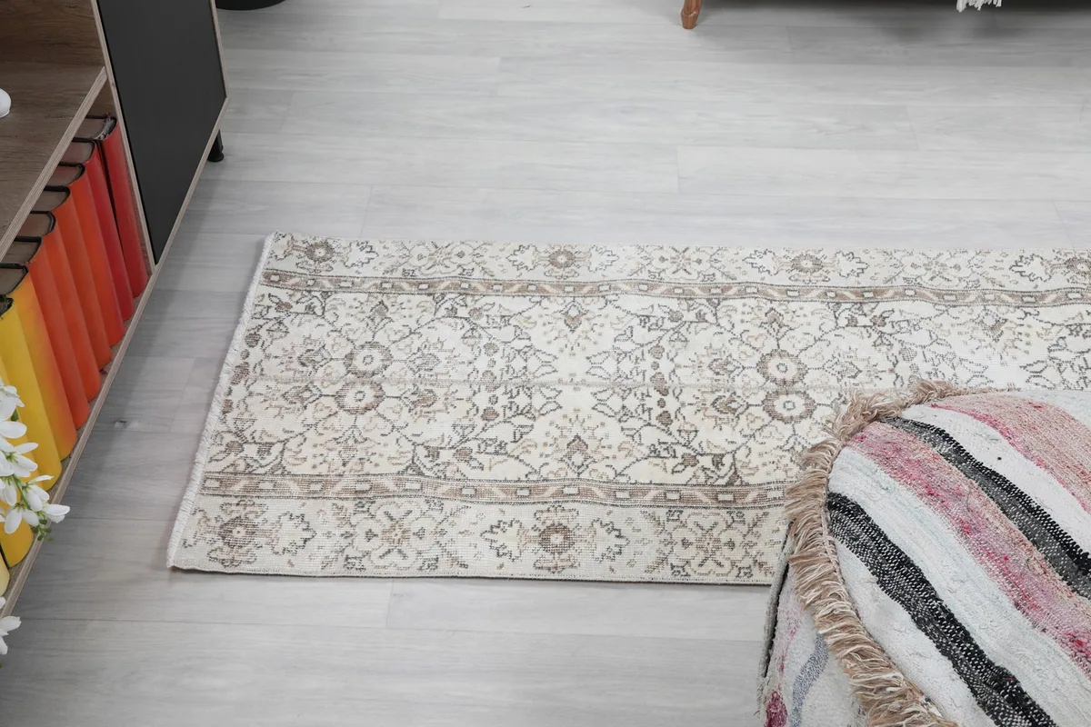 Wide angle view of the runner rug on a light floor, from the side.