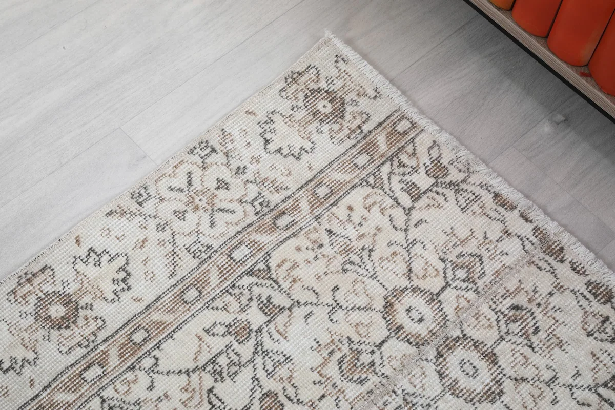 Detail of the rug's corner and border design with its intricate patterns.