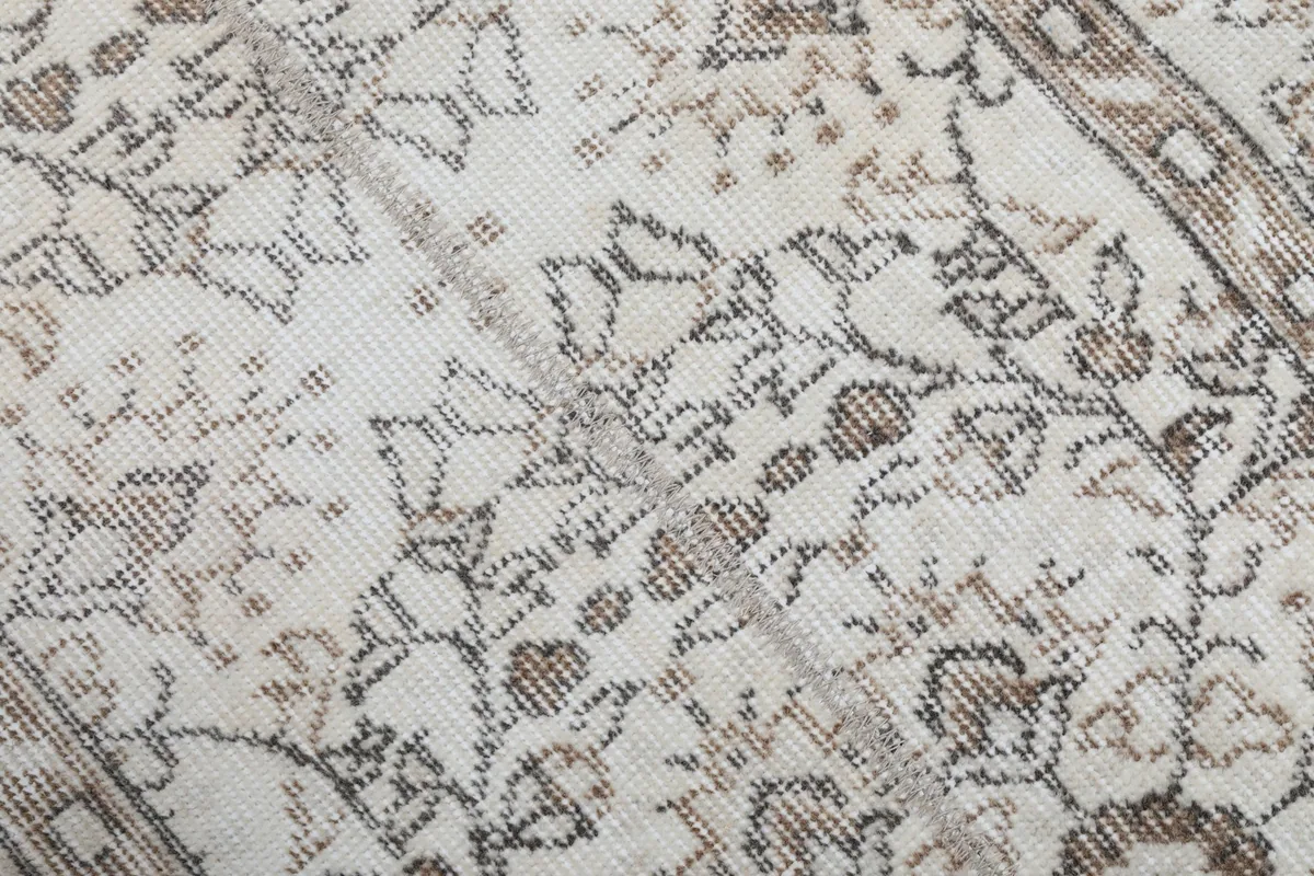 Extreme close-up of the low wool pile and hand-knotted texture.