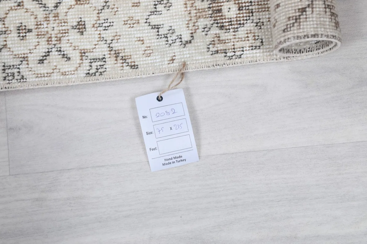 Product tag attached to the rug, indicating it is handmade in Turkey.