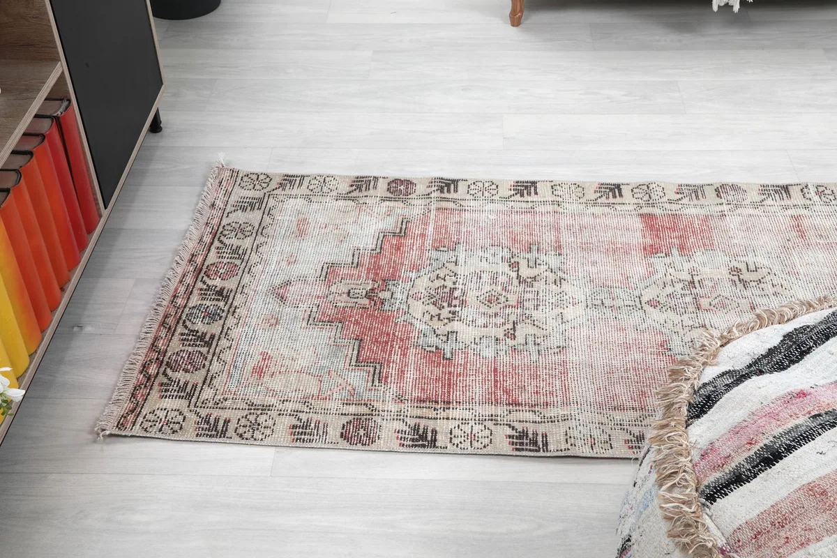 Angle view of the rug's end, highlighting the subtle color shifts and border