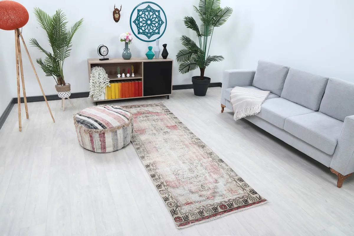 Angle view of the runner rug in a room with a sofa and ottoman