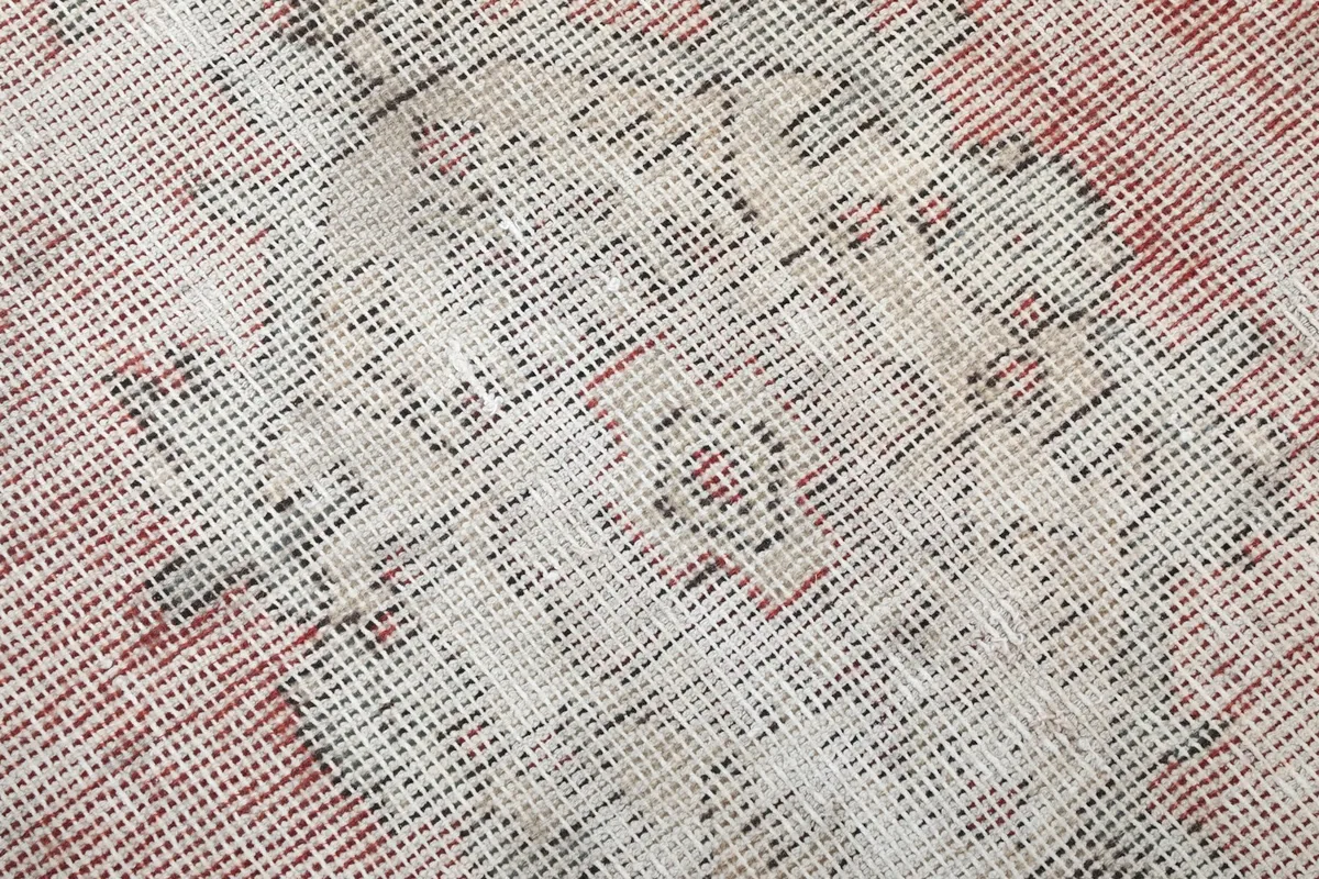 Close-up of the low wool pile and hand-knotted texture of the vintage rug
