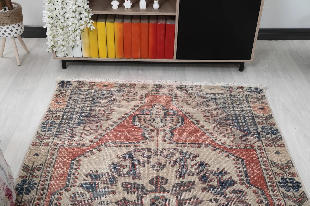 View of the vintage rug from a different angle in the living room, highlighting its colors