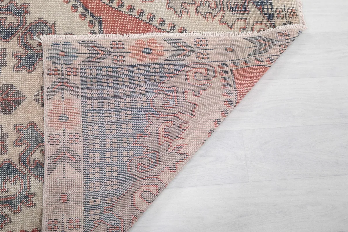 Another view of the back of the rug, detailing the knotting and fringe