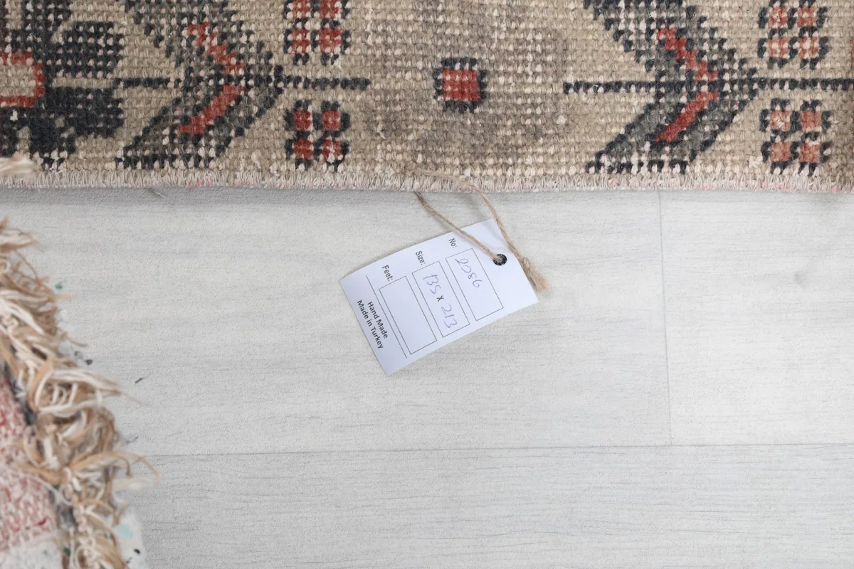 Close-up of the rug's tag, indicating it is professionally cleaned and vintage