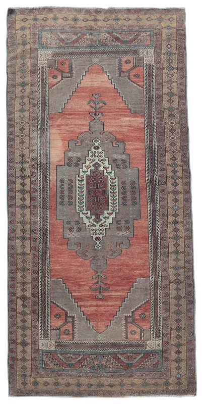 Full overhead view of the rust and gray vintage Anatolian runner rug on a white background.