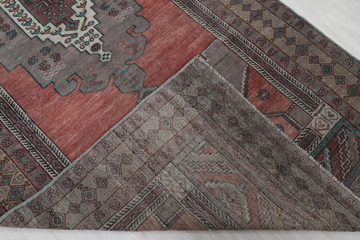 View of the rug's reverse side, showing the hand-knotted construction and cotton foundation.