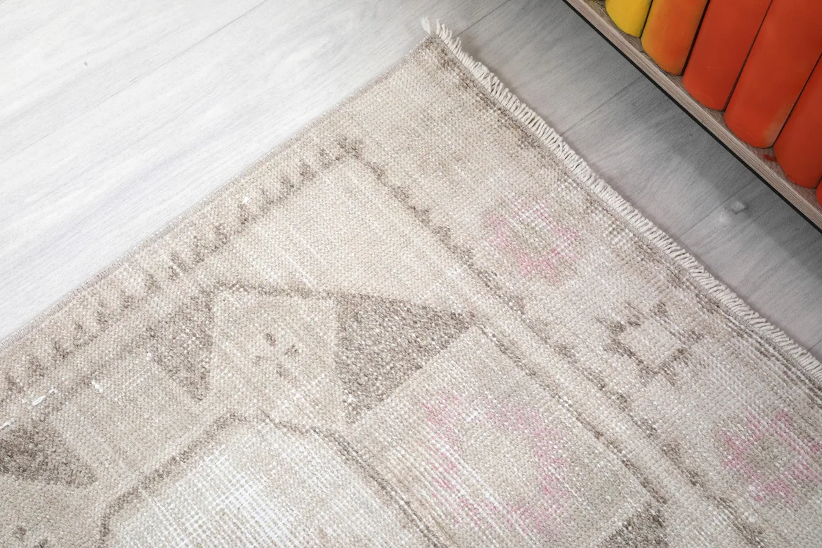 Corner detail of the rug showing a geometric pattern and border design