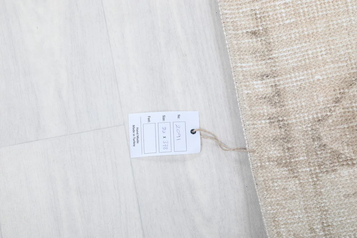 Product tag displaying the rug's size and origin details next to the rug