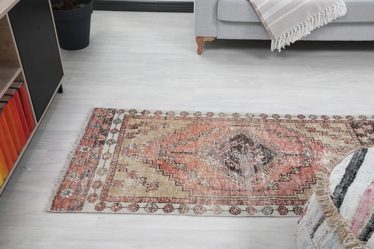 Angled shot of the runner rug in the room, focusing on its placement relative to furniture.