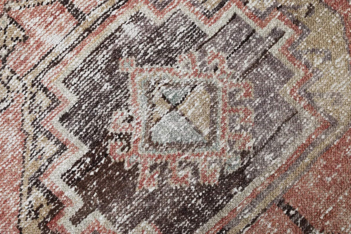 Very close detail of the rug's central design, highlighting individual knots and color variations.
