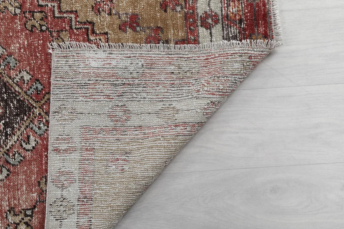 Another view of the rug's back, showing the consistent hand-knotted structure and fringe.