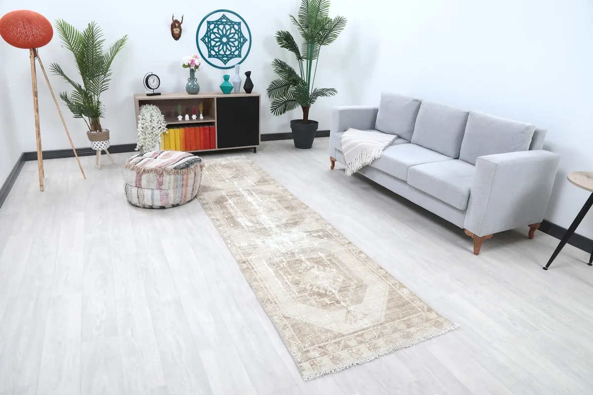 Angled view of the runner rug in a room, showing its length and how it complements the light flooring and decor.