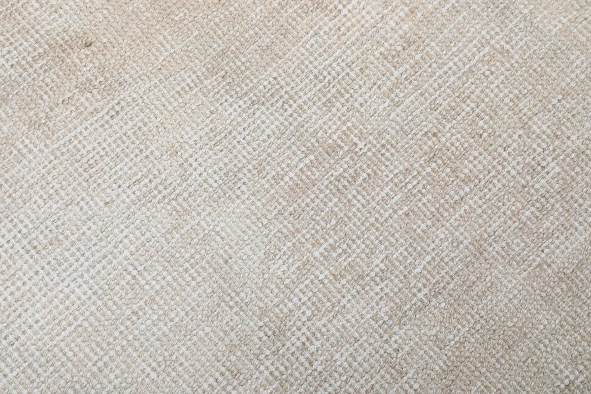 Close-up of the low wool pile texture and hand-knotted construction of the rug