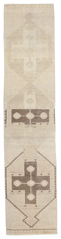 Full top view of the beige and brown tribal geometric runner rug on a white background.