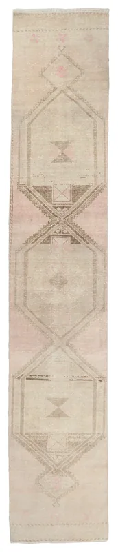 Full overhead view of the beige and rose vintage Anatolian runner rug with geometric patterns