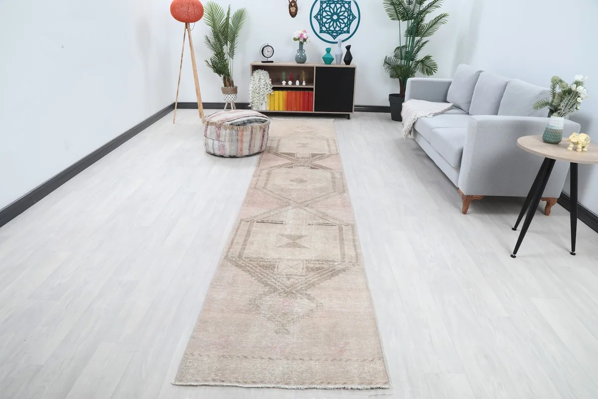 Vintage beige and rose runner rug displayed in a modern living room setting