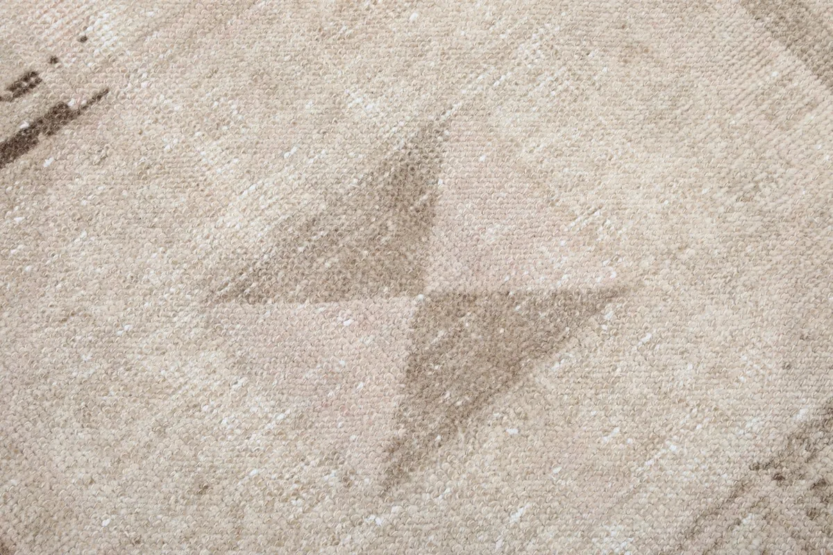 Detailed view of the diamond-like motifs and color variation within the rug's pile