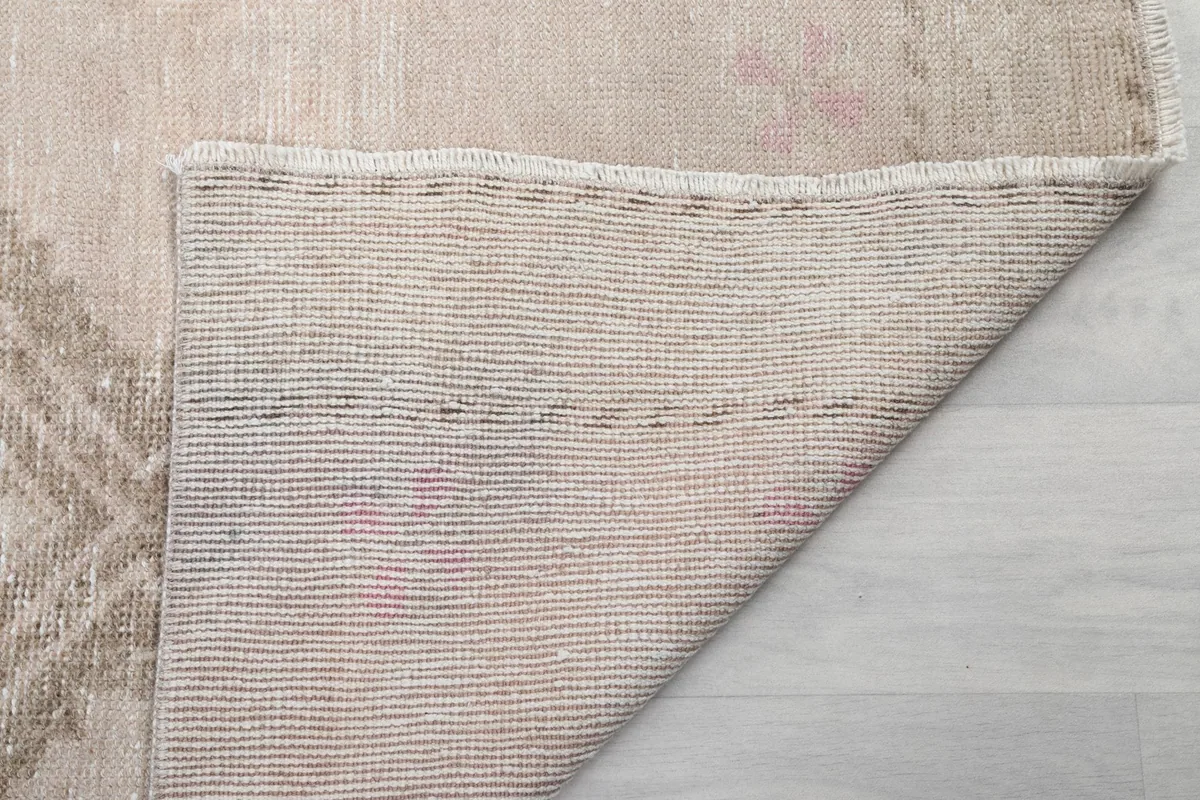 Underside of the hand-knotted rug, revealing the cotton foundation and knotting structure