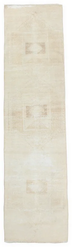 Full overhead view of the beige and tan geometric vintage runner rug