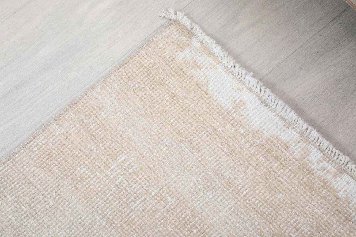 Corner detail showing the hand-knotted edge and faint patterns