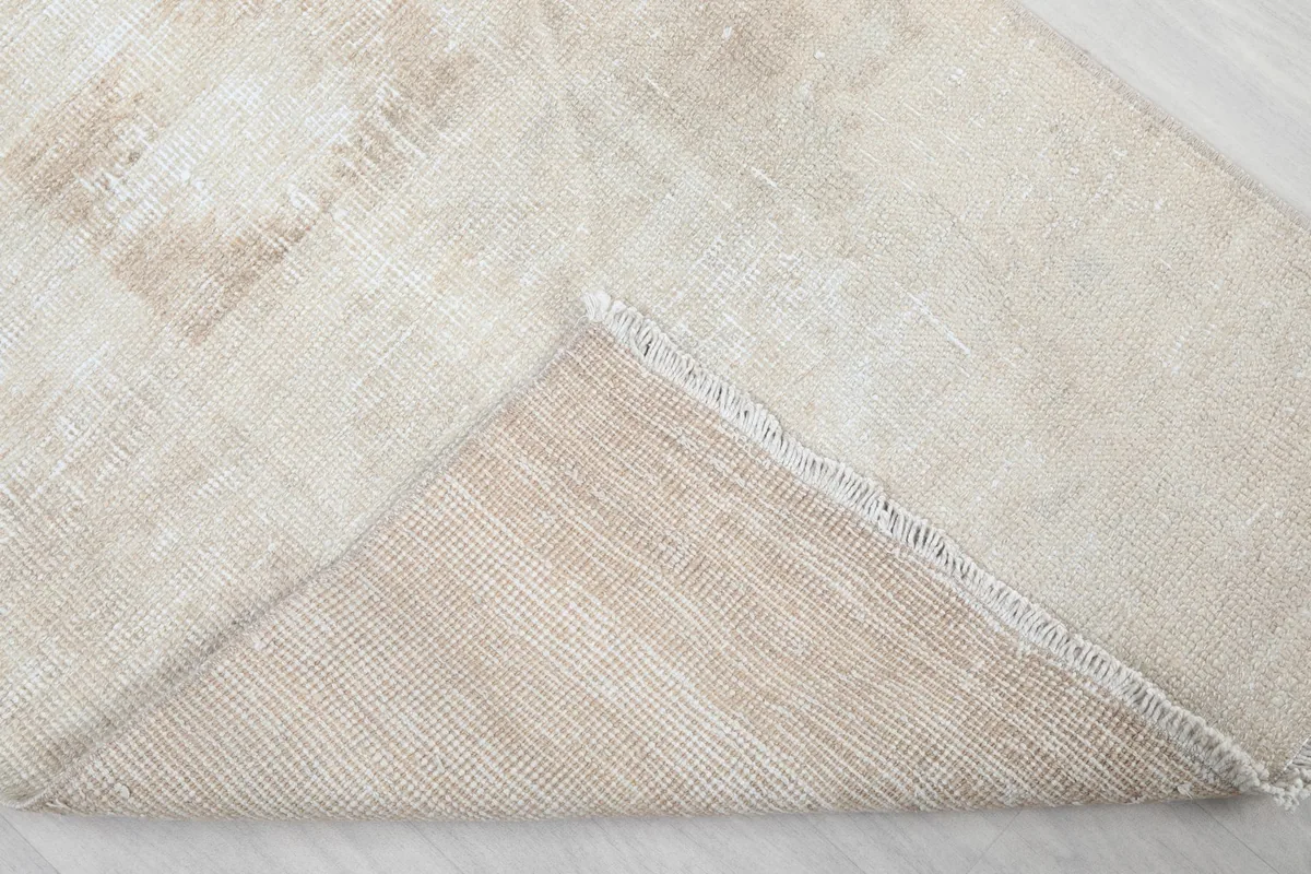 Underside of the rug, revealing the cotton foundation and hand-knotted construction