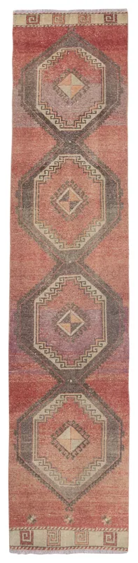 Full top view of the rust geometric Anatolian runner rug with gray and purple medallions on a white background.