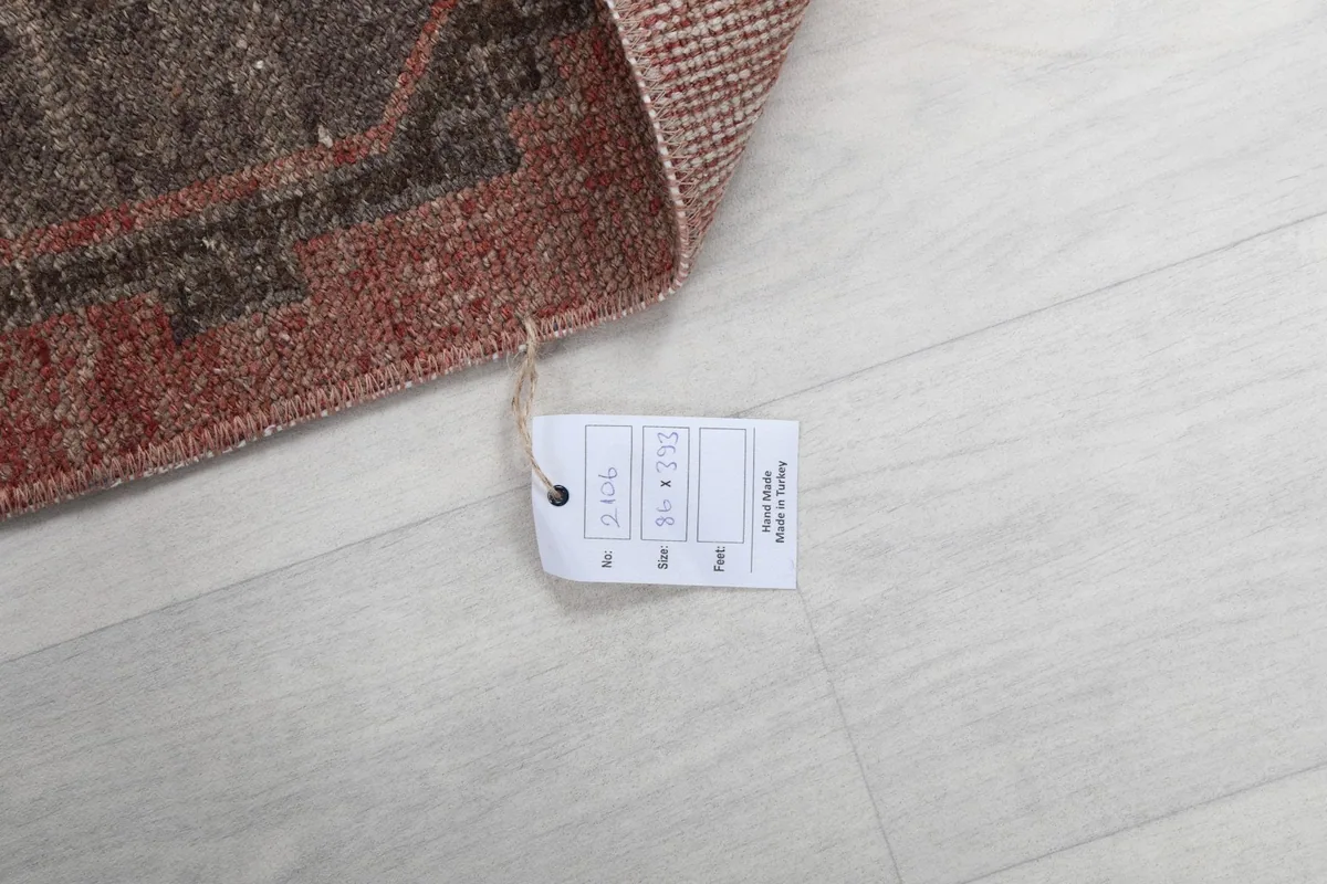 Detail of the product tag attached to the rug, showing information like size and origin.
