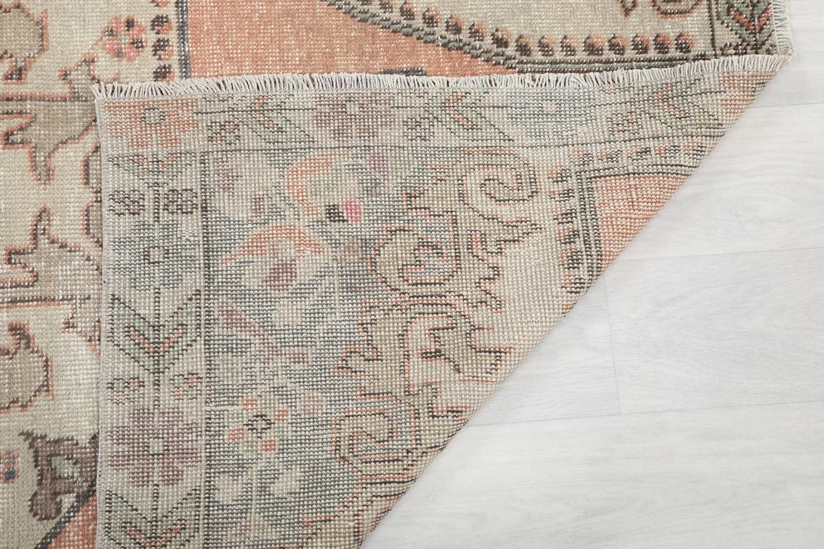 Underside view of the rug, showing the hand-knotted construction and fringe.