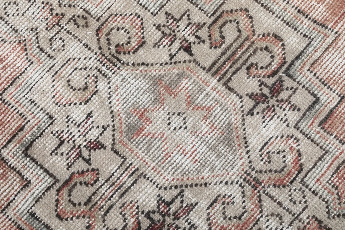 Extremely close-up view of the wool pile, showing the texture and the hand-knotted weave.