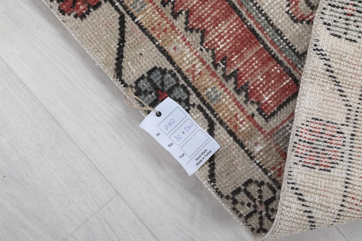 Corner of the rug with a product tag, indicating its origin and material details.