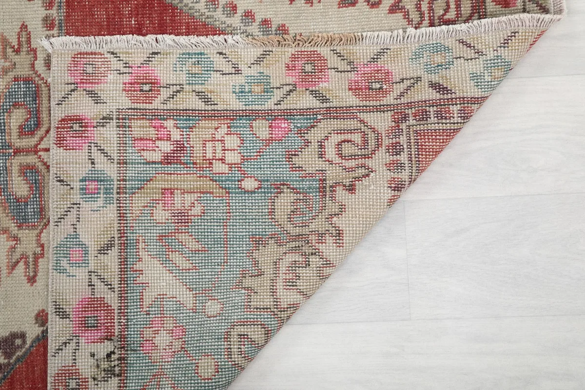 Close-up of the back of the rug, showing the knotting and fringe detail