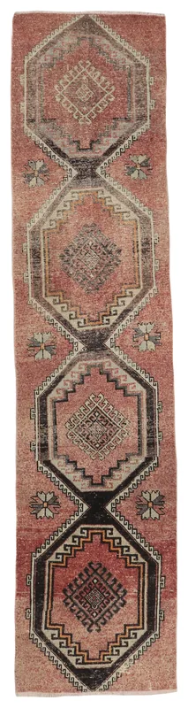 Full top view of the 2'7" x 12'0" vintage Anatolian runner rug with rust and black geometric medallions.