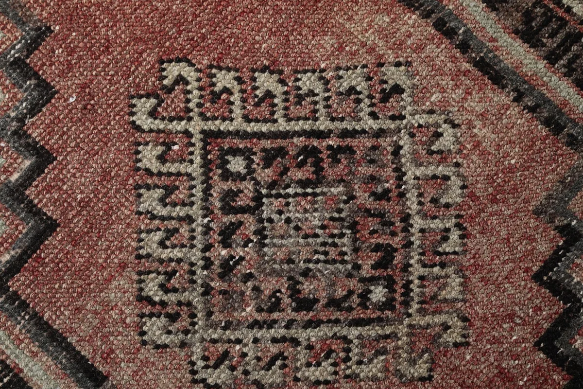 Extreme close-up of the central pattern within a medallion, revealing the texture and subtle color variations.