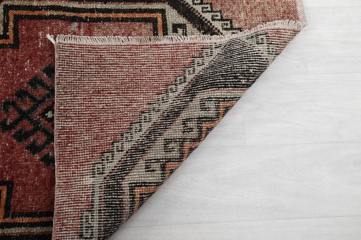 Underside of the rug showing the tight knotting on the cotton foundation, indicating quality craftsmanship.