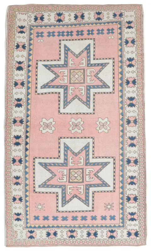 Full overhead view of the vintage rose geometric area rug on a white background.